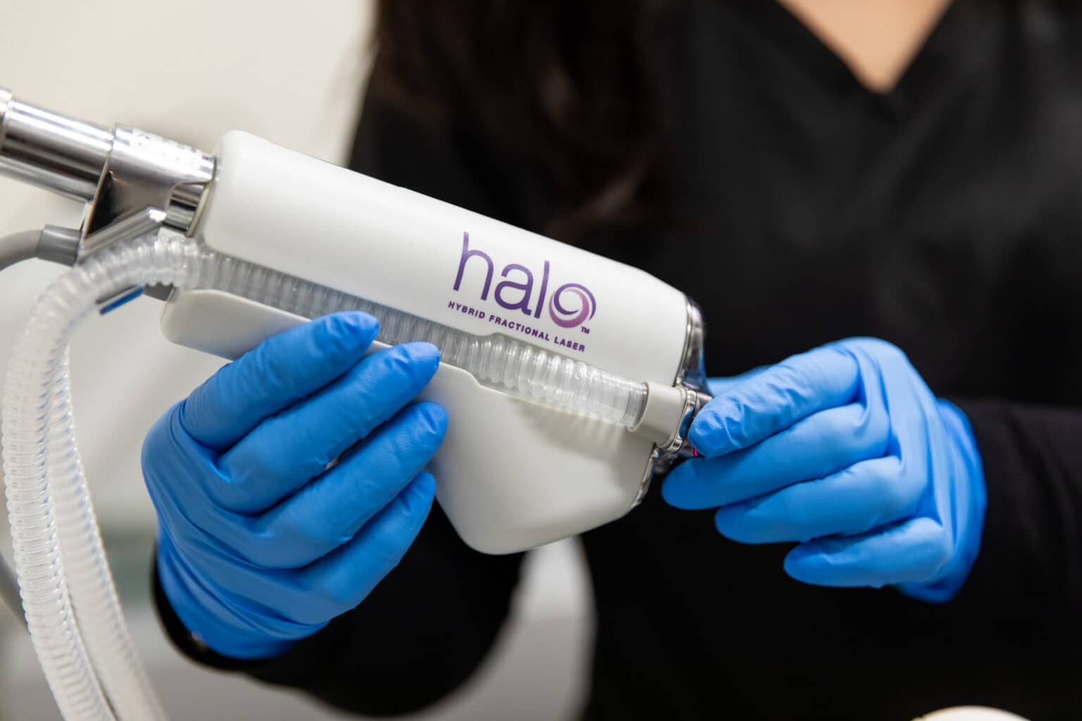 Provider adjusting settings on the HALO laser before a resurfacing treatment